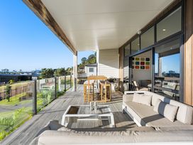 A deck with outdoor furniture and a view at Panorama View Retreat - Bachcare Holiday Home Pauanui