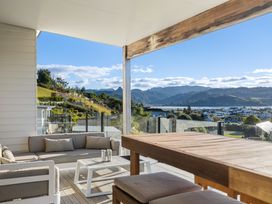 A seating area with a sofa and table at Panorama View Retreat - Bachcare Holiday Home, Pauanui