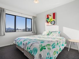 A bedroom with a bed and window at Panorama View Retreat - Bachcare Holiday Home Pauanui