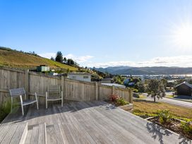 An outdoor area with chairs and a deck at Panorama View Retreat - Pauanui