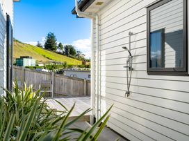 An outdoor area with a shower and a wooden deck at Panorama View Retreat - Bachcare Holiday Home Pauanui