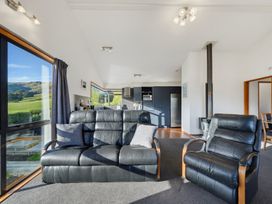 A living room with a sofa and armchair at Belle Vue in Akaroa