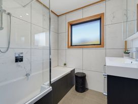 A bathroom with a shower and bathtub at Belle Vue Akaroa
