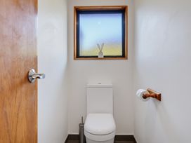 A bathroom with a toilet and a window at Belle Vue in Akaroa