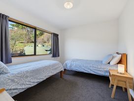A bedroom with two beds and a window at Belle Vue in Akaroa