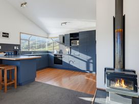 A kitchen with appliances and furniture at Belle Vue in Akaroa