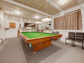 A game room with a pool table and shelves at Belle Vue in Akaroa