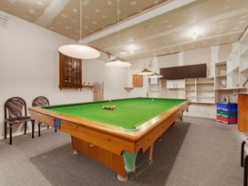 A game room with a pool table and chairs at Belle Vue in Akaroa