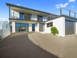 A house with a balcony and garage at Belle Vue in Akaroa