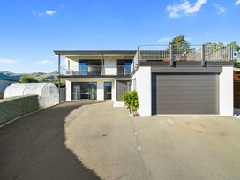 A house with a balcony and garage at Belle Vue in Akaroa