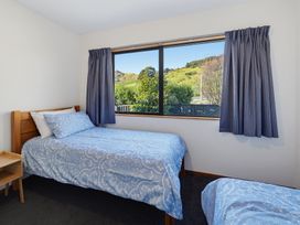 A bedroom with two beds and a window at Belle Vue in Akaroa