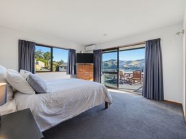 A bedroom with a bed and television at Belle Vue in Akaroa