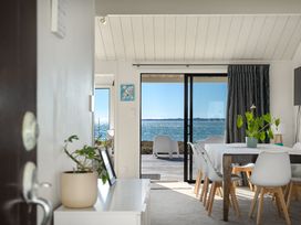 A dining room with a table and chairs at Sandbanks, Papamoa Holiday Home in Papamoa
