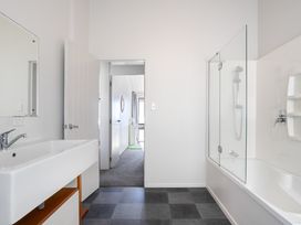 A bathroom with a sink and shower at Sandbanks, Papamoa Holiday Home, Papamoa
