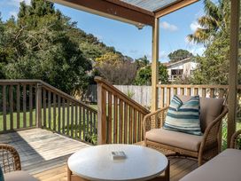 An outdoor seating area with a deck and couch at Calden Cottage - Ngurunguru Holiday Home Ngunguru