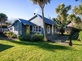 A house with a stone path and yard at Thimble Cottage, Ashburton Holiday Home in Methven