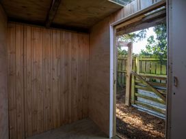 An interior view of a shed with wooden walls and an open door at Thimble Cottage, Ashburton Holiday Home, Methven