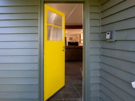 An entrance with a yellow door leading to a living area at Thimble Cottage, Ashburton Holiday Home, Methven