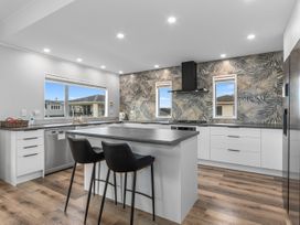 A kitchen with modern appliances and an island at Seaside Escape - Ruakaka Holiday Home in Ruakaka