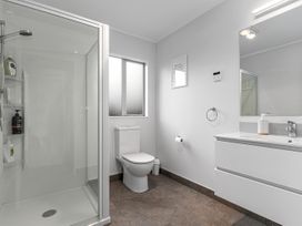 A bathroom with a shower and a toilet at Seaside Escape - Ruakaka Holiday Home in Ruakaka