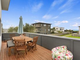 An outdoor patio with a dining table and chairs at Seaside Escape - Ruakaka Holiday Home Ruakaka