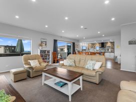 A living room with a sofa and coffee table at Seaside Escape - Ruakaka Holiday Home Ruakaka