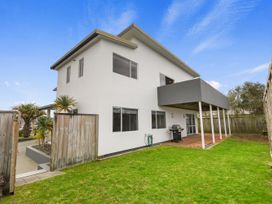 An outdoor area with a house and deck at Seaside Escape - Ruakaka Holiday Home, Ruakaka