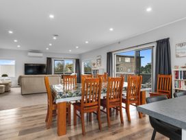 A dining room with a table and chairs at Seaside Escape - Ruakaka Holiday Home in Ruakaka