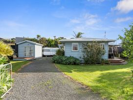 A house with a deck and a cabin in the garden at Coastal Hideaway - Waipu Cove Holiday Home Waipu