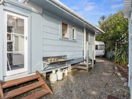 An outdoor area with a pathway and table at Coastal Hideaway - Waipu Cove Holiday Home Waipu