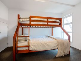 A bunk bed and double bed in a bedroom at Urban Oasis - Christchurch Holiday Home Christchurch