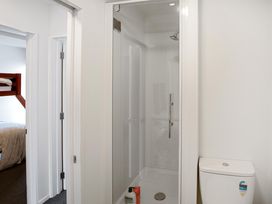 A bathroom with a shower and toilet at Urban Oasis - Christchurch Holiday Home in Christchurch