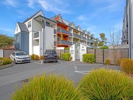 An outdoor area with parked cars and buildings at Urban Oasis - Christchurch Holiday Home, Christchurch