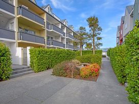 An outdoor area with buildings, a walkway, and greenery at Urban Oasis - Christchurch Holiday Home Christchurch