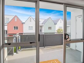 A balcony view showing colored houses at Urban Oasis - Christchurch Holiday Home in Christchurch