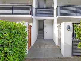 An outdoor entryway with a staircase and hedges at Urban Oasis - Christchurch Holiday Home Christchurch