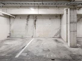A parking garage with numbered spaces at Urban Oasis - Christchurch Holiday Home, Christchurch