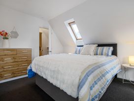 A bedroom with a bed and dressing table at Urban Oasis - Christchurch Holiday Home, Christchurch