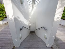 A staircase leading down to a door at Urban Oasis - Christchurch Holiday Home Christchurch