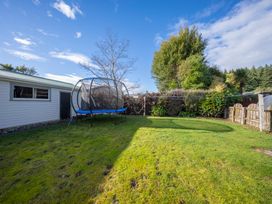 A garden with a trampoline and shed at Quiet on Quintin - Te Anau Holiday Home in Te Anau