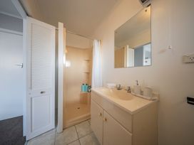 A bathroom with a sink and shower at Quiet on Quintin - Te Anau Holiday Home
