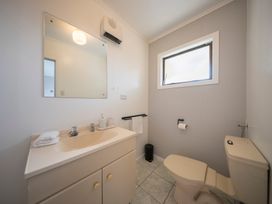 A bathroom with a sink and toilet at Quiet on Quintin - Te Anau Holiday Home in Te Anau