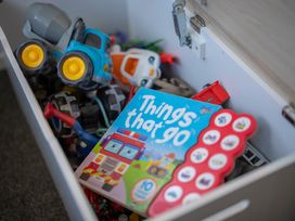 A toy box filled with trucks and a book titled Things That Go at Quiet on Quintin - Te Anau Holiday Home