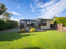 A house with a garden and pathway at Quiet on Quintin - Te Anau Holiday Home Te Anau