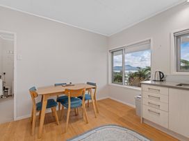 A dining area with a table and chairs at Serenity Above the Lake - Acacia Bay