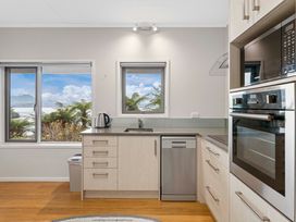 A kitchen with windows and appliances at Serenity Above the Lake - Acacia Bay