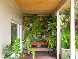 An outdoor area with a bench and a plant wall at Serenity Above the Lake - Acacia Bay Holiday Home Acacia Bay