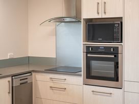 A kitchen featuring an oven, microwave, and a dishwasher at Serenity Above the Lake - Acacia Bay