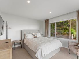 A bedroom with a bed and television at Serenity Above the Lake - Acacia Bay