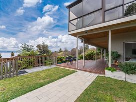 An outdoor area with a deck and plants at Serenity Above the Lake - Acacia Bay